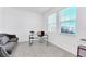 Bright home office with a comfortable couch and large windows at 157 Pineywoods St, St Cloud, FL 34769