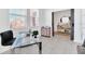 Home office with glass desk and built-in shelving at 157 Pineywoods St, St Cloud, FL 34769