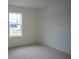 Well-lit bedroom with carpeted floor and large window at 1655 Andover Ridge Dr, Deland, FL 32720