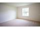 Bright bedroom with carpeted floors and large window at 1655 Andover Ridge Dr, Deland, FL 32720