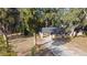 Ranch style home with covered porch and driveway, situated on a tree-lined lot at 176 E Grandbend Ave, Lake Mary, FL 32746