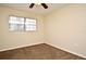 Bedroom with ceiling fan, brown carpet, and large window at 176 E Grandbend Ave, Lake Mary, FL 32746