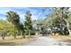 Ranch style home with driveway, surrounded by mature trees at 176 E Grandbend Ave, Lake Mary, FL 32746