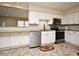 Eat-in kitchen with white cabinets, granite counters, and stainless steel appliances at 176 E Grandbend Ave, Lake Mary, FL 32746