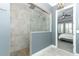 Modern shower with tile surround and glass partition in the primary bathroom at 179 Hillcrest Dr, Oviedo, FL 32765