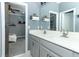 Well-lit bathroom with double sink vanity and view into the primary bedroom at 179 Hillcrest Dr, Oviedo, FL 32765