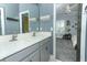 Bathroom with a double sink vanity, modern fixtures, and decorative mirror detailing at 179 Hillcrest Dr, Oviedo, FL 32765