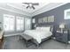 Cozy bedroom with a tray ceiling, carpet flooring, and neutral decor at 179 Hillcrest Dr, Oviedo, FL 32765