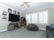 Well-lit bonus room with plantation shutters and arcade game at 179 Hillcrest Dr, Oviedo, FL 32765