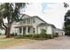 Charming home featuring a brick driveway, mature landscaping, and a welcoming front porch at 179 Hillcrest Dr, Oviedo, FL 32765