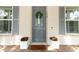 Charming front door adorned with a wreath, flanked by elegant planters and stylish shutters at 179 Hillcrest Dr, Oviedo, FL 32765