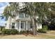 Charming two-story home featuring a classic front porch and mature landscaping at 179 Hillcrest Dr, Oviedo, FL 32765