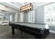 This is a spacious game room with a pool table, custom lighting, and a comfortable window seat at 179 Hillcrest Dr, Oviedo, FL 32765