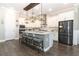 Spacious kitchen with a large island, modern appliances, and stylish pendant lighting at 179 Hillcrest Dr, Oviedo, FL 32765