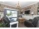 This living room leads to the patio and pool area, with a brick accent wall and comfortable seating at 179 Hillcrest Dr, Oviedo, FL 32765