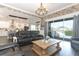 The living room boasts a sliding glass door to the patio and pool area, and a brick accent wall at 179 Hillcrest Dr, Oviedo, FL 32765