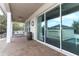 Covered brick patio featuring a porch swing, and view of pool and garage at 179 Hillcrest Dr, Oviedo, FL 32765
