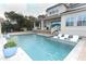 A stunning backyard pool featuring in-pool loungers, a covered patio, and elegant landscaping at 179 Hillcrest Dr, Oviedo, FL 32765