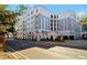 Beautiful condo building with white and gray exterior design and manicured landscaping at 202 E South St # 1048, Orlando, FL 32801
