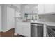 Modern kitchen with white cabinets, stainless steel appliances, and a breakfast bar at 202 E South St # 1048, Orlando, FL 32801