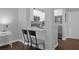 Kitchen with breakfast bar, white cabinets, and stainless steel appliances at 202 E South St # 1048, Orlando, FL 32801
