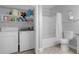 Laundry room with washer, dryer, and storage shelves at 202 E South St # 1048, Orlando, FL 32801
