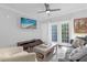 Living room with dark gray sofa, large TV, and access to a balcony at 202 E South St # 1048, Orlando, FL 32801