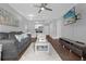 Living room with gray couch, coffee table and view into kitchen at 202 E South St # 1048, Orlando, FL 32801