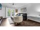 Living room with gray couch, balcony access, and a home office area at 202 E South St # 1048, Orlando, FL 32801