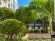 Community pool with lush landscaping and palm trees at 202 E South St # 1048, Orlando, FL 32801