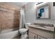 Bathroom with beige tile, granite countertop, and white cabinets at 2031 Eaton St, Maitland, FL 32751