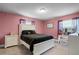 Bedroom with a queen bed and pink walls at 2031 Eaton St, Maitland, FL 32751