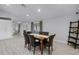 Dining room with wooden table and leather chairs, view into living room at 2031 Eaton St, Maitland, FL 32751
