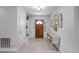 Bright entryway with wood flooring, a console table, and wood door at 2031 Eaton St, Maitland, FL 32751