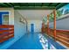 Covered patio with blue door and wood railings at 2414 Herbison Dr, Orlando, FL 32810