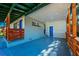Covered patio with blue door and wood railings at 2414 Herbison Dr, Orlando, FL 32810