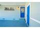 Covered back patio with blue door and wooden accents at 2414 Herbison Dr, Orlando, FL 32810
