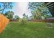 Large backyard with fenced in area and green grass at 2414 Herbison Dr, Orlando, FL 32810