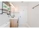 Modern bathroom with a floating vanity, updated lighting, and marble floors at 2414 Herbison Dr, Orlando, FL 32810