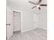 Bright bedroom with ceiling fan, closet, and vinyl flooring at 2414 Herbison Dr, Orlando, FL 32810