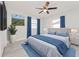 Spacious bedroom with ceiling fan, plush bedding, and large window at 2414 Herbison Dr, Orlando, FL 32810