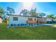 Newly renovated home with a modern exterior and well-manicured lawn at 2414 Herbison Dr, Orlando, FL 32810