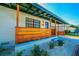 Inviting front porch with wooden railings and landscaping at 2414 Herbison Dr, Orlando, FL 32810