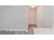 Clean and bright hallway with light gray walls and wood-look floors at 2414 Herbison Dr, Orlando, FL 32810