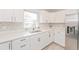 Modern white kitchen with stainless steel appliances and quartz countertops at 2414 Herbison Dr, Orlando, FL 32810