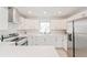 Modern kitchen with stainless steel appliances and white cabinets at 2414 Herbison Dr, Orlando, FL 32810