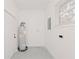 Laundry area with new water heater and window at 2414 Herbison Dr, Orlando, FL 32810