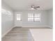 Bright and airy living room with light gray walls and wood-look floors at 2414 Herbison Dr, Orlando, FL 32810