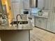 Modern kitchen with gray cabinets and granite countertops at 247 Cranbrook Dr, Kissimmee, FL 34758