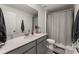 Clean bathroom with gray vanity, shower/tub combo, and updated fixtures at 2559 Relaxing Ln, Kissimmee, FL 34747